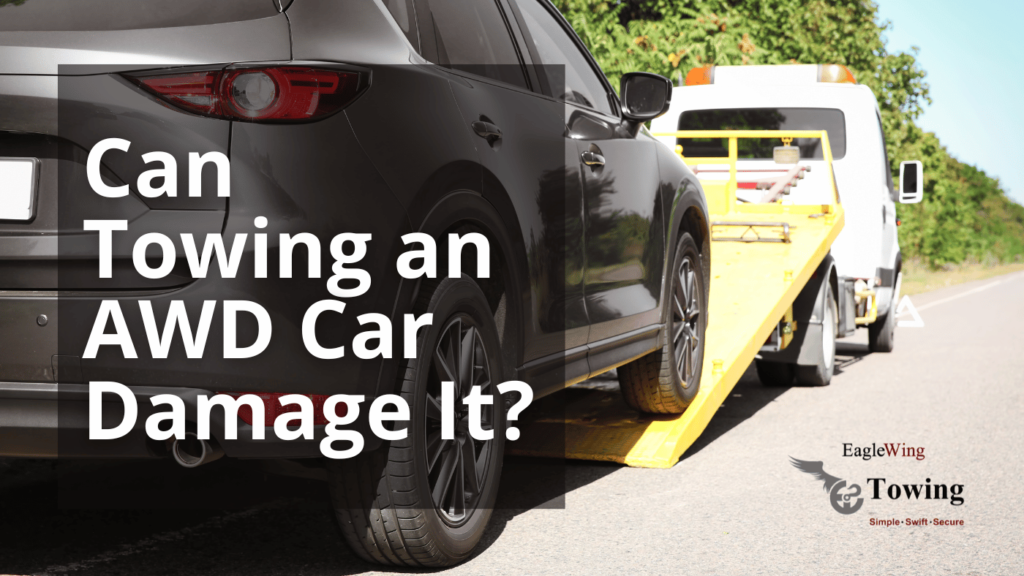 A black AWD car being loaded onto a flatbed tow truck, illustrating the question 'Can towing an AWD car damage it?' by Eagle Wing Towing.