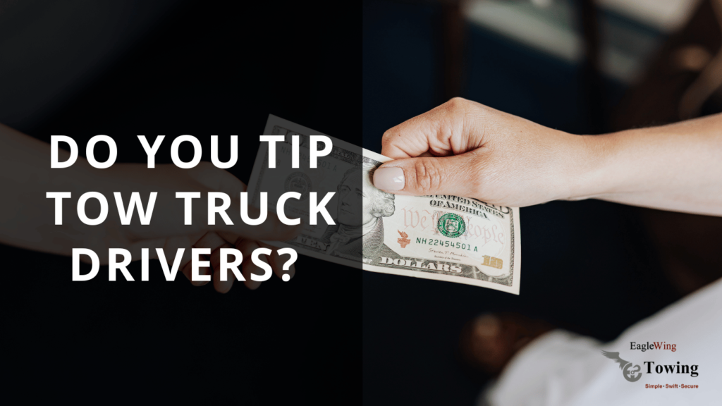 A person handing a tip to a tow truck driver, illustrating the topic 'Do you tip tow truck drivers?' from Eagle Wing Towing.