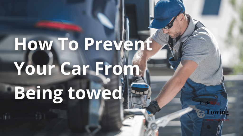 A towing professional securing a car onto a tow truck, illustrating tips on how to prevent your car from being towed by Eagle Wing Towing.